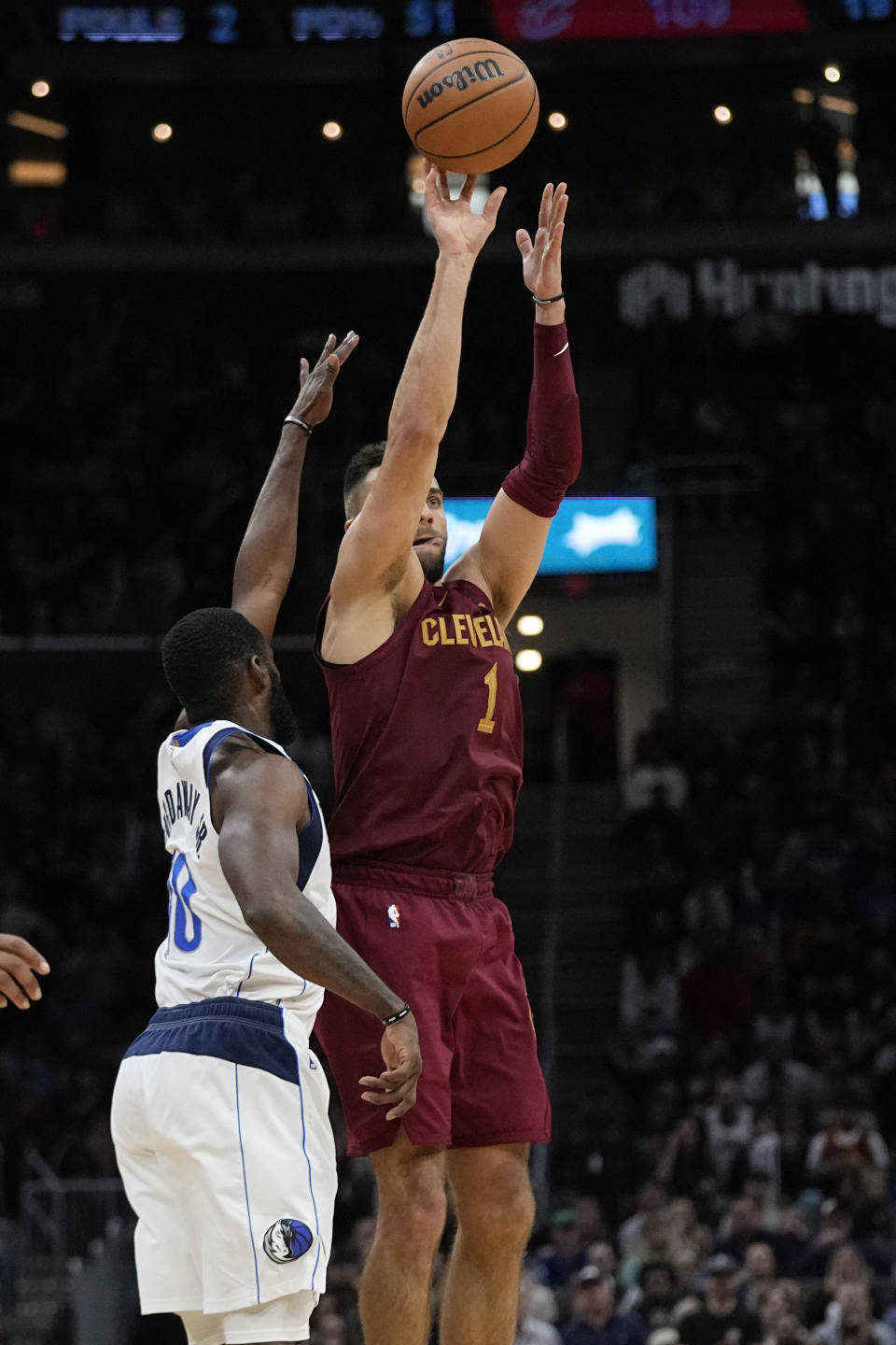 Cleveland Cavaliers guard Max Strus (1) shoots a 3-point basket next to Dallas Mavericks forward Tim Hardaway Jr. (10) during the second half of an NBA basketball game Tuesday, Feb. 27, 2024, in Cleveland. (AP Photo/Sue Ogrocki)