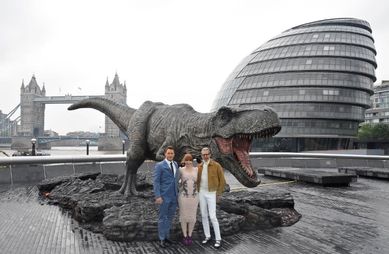 Chris Pratt, Bryce Dallas Howard, and Jeff Goldblum pose with a T. rex statue in London. (Photo: Reuters)