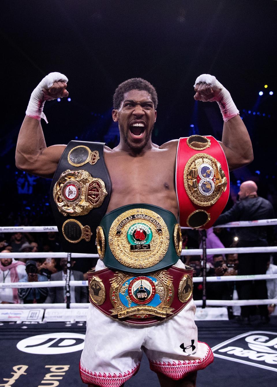 Joshua posing with multiple heavyweight belts in 2007Getty Images