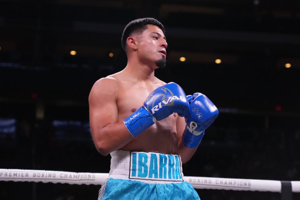 Jesus Abel Ibarra (blue trunks) and Ernesto Guerrero (black trunks) box during a Premier Boxing Champions card at Gila River Arena.