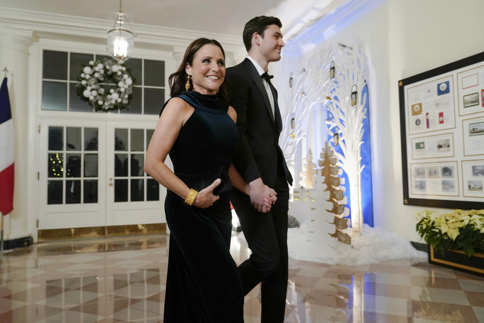 Actress Julia Louis-Dreyfus and her son actor Charlie Hall arrive for the State Dinner with President Joe Biden and French President Emmanuel Macron at the White House in Washington, Thursday, Dec. 1, 2022. (AP Photo/Susan Walsh)