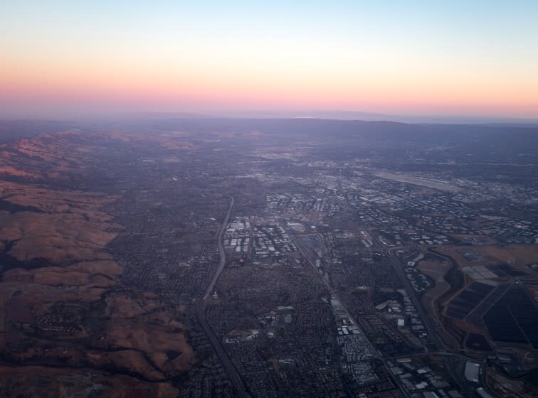 Aerial view of Silicon Valley at dusk, including the towns of Milpitas, Santa Clara, and San Jose, with the Mineta San Jose International Airport visible, California, July, 2016. (Photo by Smith Collection/Gado/Getty Images).
