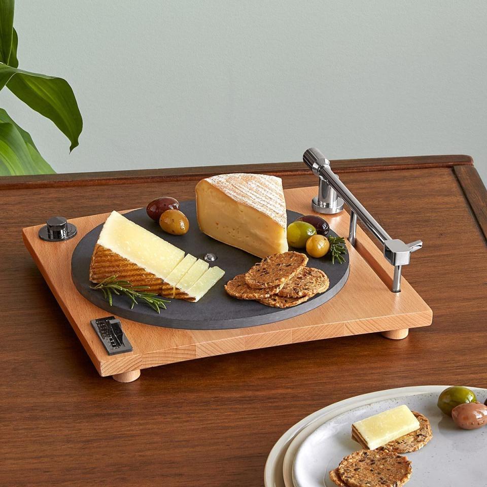 <p><strong>Uncommon Goods</strong></p><p>uncommongoods.com</p><p><strong>$78.00</strong></p><p>Set the mood for the dinner party with a turntable-inspired cheese board to present those delicious hors d'oeuvres. It even has a slate platter and hidden slicer. </p>