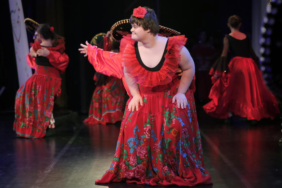 In this Dec. 3, 2019, photograph children with Down syndrome perform in a dance show, in Bucharest, Romania. Children with Down syndrome staged a fashion show and performed along a ballet ensemble, two milestone events for the inclusion of people with disabilities in Romania's social life, 30 years after the fall of communism following a violent uprising at the end of 1989.(AP Photo/Vadim Ghirda)