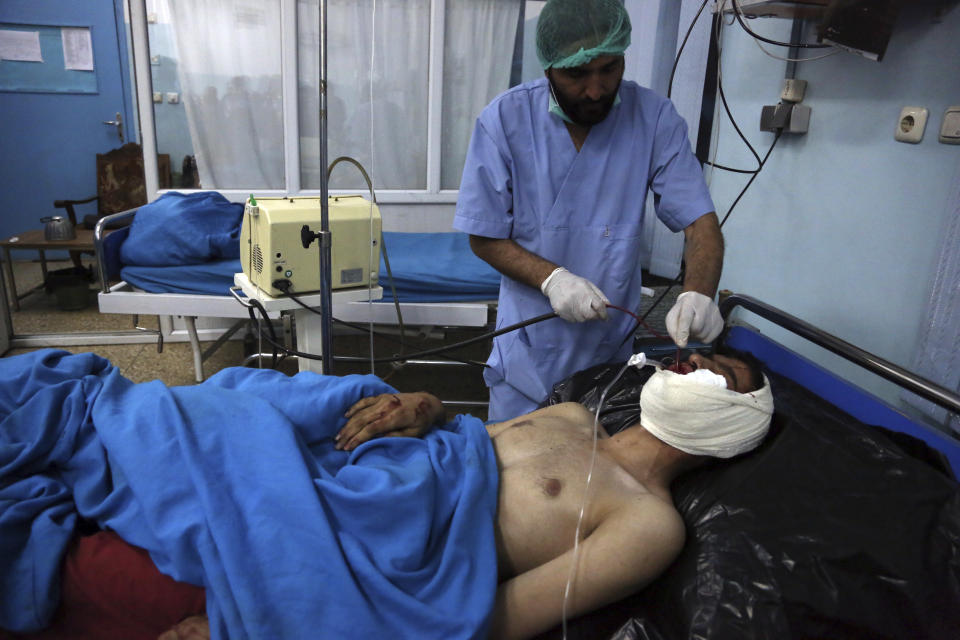 An injured man receives treatment at a hospital after a suicide bombing in Kabul, Afghanistan, Nov. 20, 2018. Afghan officials said the suicide bomber targeted a gathering of Muslim religious scholars in Kabul, killing tens of people. A Public Health Ministry spokesman said another 60 people were wounded in the attack, which took place as Muslims around the world marked the birthday of the Prophet Mohammad. (AP Photo/Rahmat Gul)