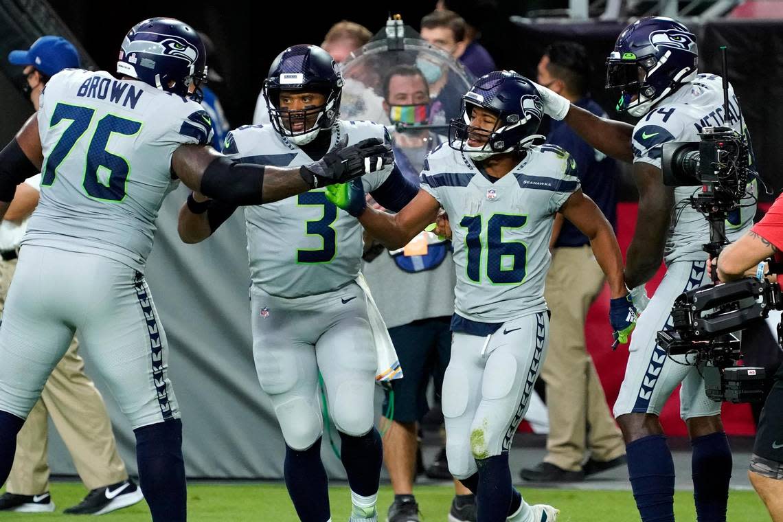 Seattle Seahawks wide receiver Tyler Lockett (16) celebrates his touchdown with quarterback Russell Wilson (3), offensive tackle Duane Brown (76) and offensive tackle Cedric Ogbuehi (74) during the first half of an NFL football game against the Arizona Cardinals, Sunday, Oct. 25, 2020, in Glendale, Ariz. (AP Photo/Rick Scuteri)