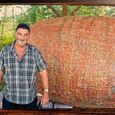 James Frank Kotera stands next to his giant ball of twine. He spent nearly 44 years collecting twine and adding it to the ball. Before he died in January, it weighed 24,100 pounds and became known as the world's heaviest ball of twine. The weight compressed the ball, giving it more of an egg shape.