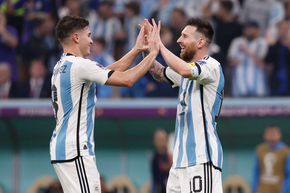 Julian Alvarez, left, celebrates with teammate Lionel Messi after scoring a goal during Argentina's World Cup semifinal victory over Croatia Tuesday at Lusail Stadium in Qatar.