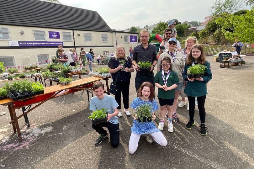 Scouts Lucy, Finlay, Sarah and Nina welcome MP Michael Shanks and Councillor Cowie to the plant sale -Credit:Burnside Scouts