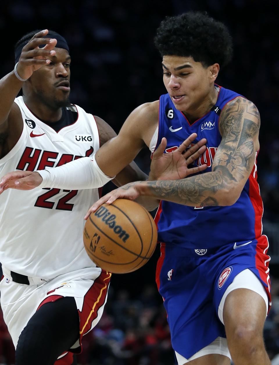 Detroit Pistons guard Killian Hayes, right, drives to the basket against Miami Heat forward Jimmy Butler (22) during the first half of an NBA basketball game Sunday, March 19, 2023, in Detroit. (AP Photo/Duane Burleson)