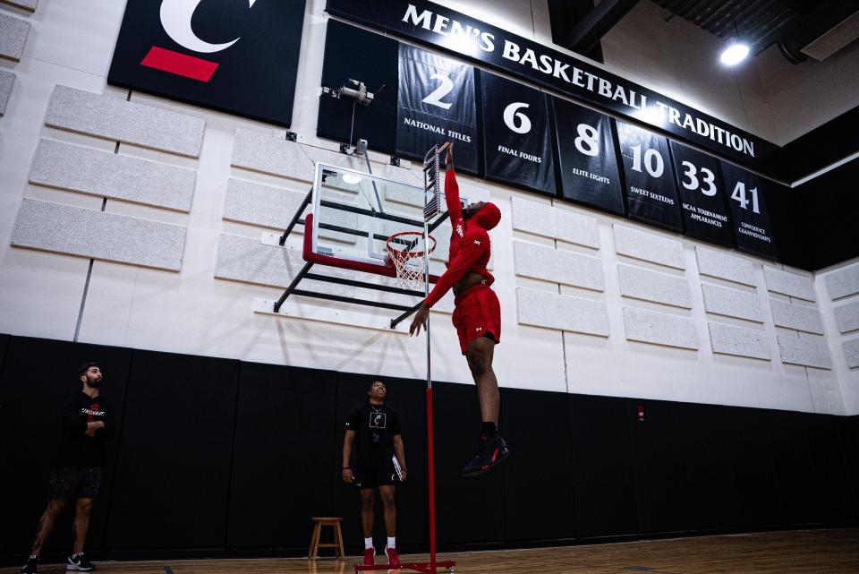 Jamille Reynolds, a 6-foot-10 transfer from Temple displays an impressive vertical leap in UC's practice gym at the Lindner Center.