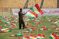 A man carries the Kurdistan flags before the start of a rally calling to vote yes in the coming referendum, in Erbil, Iraq September 22, 2017. REUTERS/Azad Lashkari