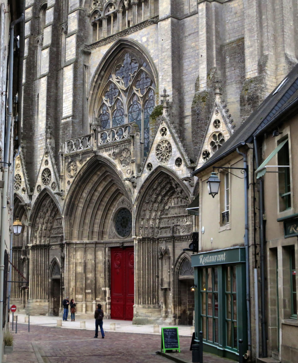 This Oct. 12, 2013 photo released by Jim MacMillan shows pedestrians outside the cathedral in Bayeux, France. The charming town sits just a few miles from the beaches of Normandy where Allied forces invaded on D-Day during World War II in 1944. (AP Photo/Jim MacMillan)