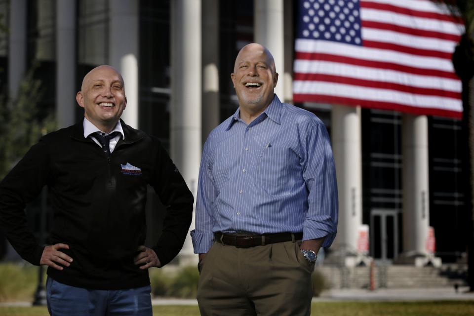 Attorney Mike Freed (left) founder of the Freed to Run fundraiser for Jacksonville Area Legal Aid, and Jim Kowalski, president/CEO of the agency, pose in front of the Duval County Courthouse. The 2023 event Nov. 17-18 will fund legal services for indigent seniors.