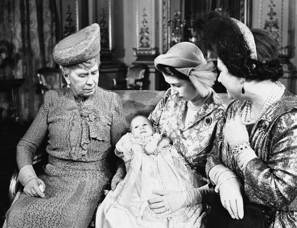 In this Oct. 21, 1950 file photo, Princess Elizabeth, center, holds her daughter, Princess Anne, in Buckingham Palace, with her mother Elizabeth at right and grandmother Mary at left, after her christening. 