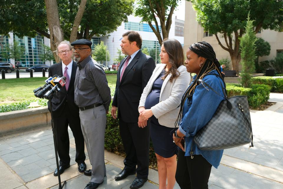 Glynn Simmons, a former death row inmate recently released after 48 years in prison, is joined by lawyers John Coyle, left, Joe Norwood and Amber Leal, as well as his cousin, Cecilia Hawthorne, right. Simmons held a news conference with his attorneys outside of the Oklahoma County Courthouse.