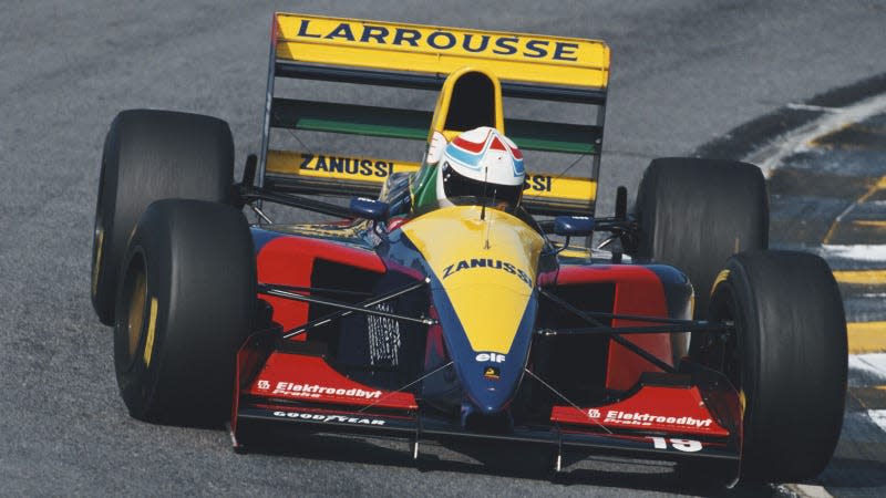 A photo of the red, yellow and blue Larrousse F1 car on track. 