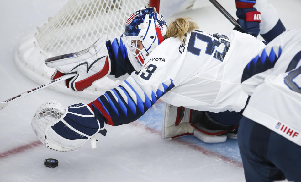 U.S. goalie Alex Cavallini, dives for the puck during the second peirod of an IIHF women's hockey championships game against Switzerland in Calgary, Alberta, Friday, Aug. 20, 2021. (Jeff McIntosh/The Canadian Press via AP)