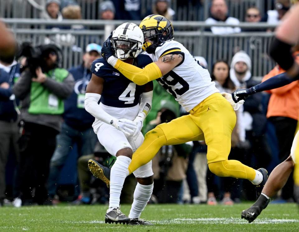 Penn State cornerback Kalen King gets called for pass interference when Michigan’s AJ Barner gets wrapped up around him during the game against Michigan on Saturday, Nov. 11, 2023. Abby Drey/adrey@centredaily.com