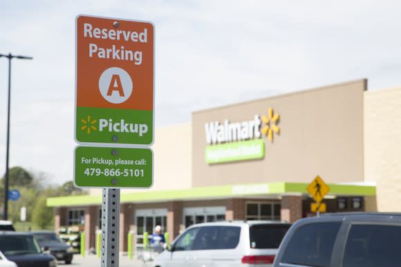 A reserved parking for online grocery pickup sign at a Walmart store.