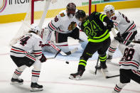 Chicago Blackhawks goaltender Malcolm Subban (30) looks on as Dallas Stars left wing Roope Hintz (24) attempts a shot during the first period of an NHL hockey game, Sunday, Feb. 7, 2021, in Dallas. (AP Photo/Sam Hodde)