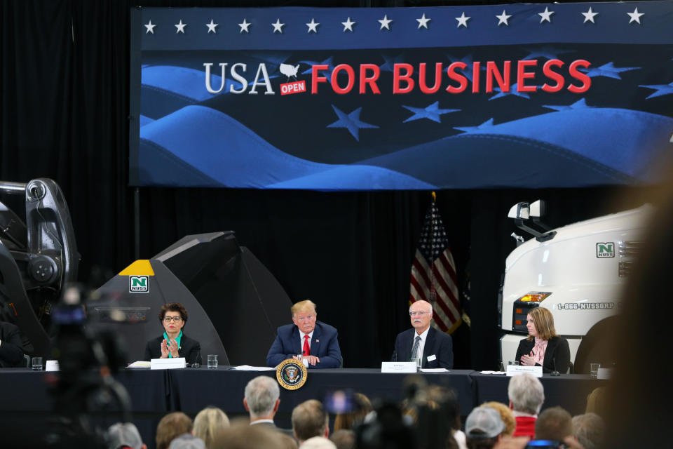 BURNSVILLE, MN - APRIL 15: (L-R) United States Treasurer Jovita Carranza, U.S. President Donald Trump and business owner Bob Nuss attend at a roundtable on the economy and tax reform at Nuss Trucking and Equipment on April 15, 2019 in Burnsville, Minnesota. At the special Tax Day roundtable Trump gave a defense of his 2017 tax cuts.(Photo by Adam Bettcher/Getty Images)
