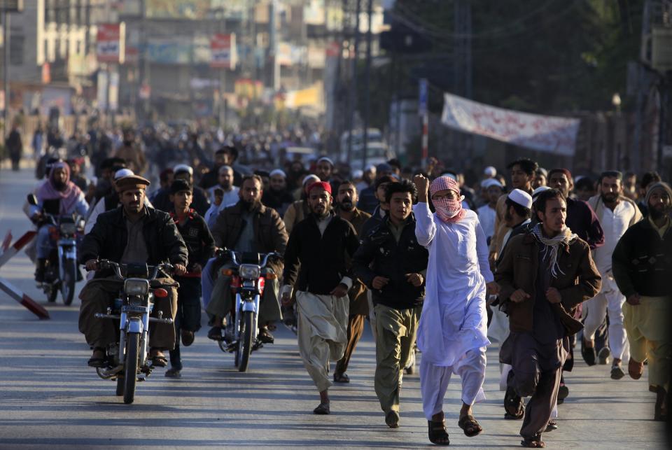 Sunni Muslims arrive to attend the funeral of fellow Sunni who were killed in Friday's sectarian clashes during a Muharram procession, Rawalpindi