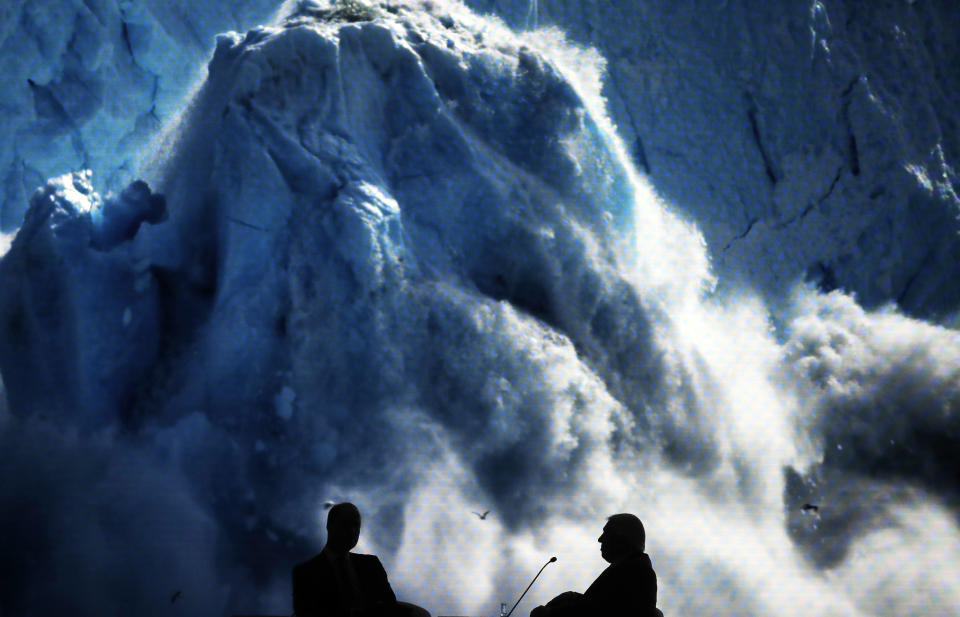 Britain's Prince William, left, and Sir David Attenborough, broadcaster and natural historian, watch the screening of Attenborough's new documentary "Our Planet" during a session at the annual meeting of the World Economic Forum in Davos, Switzerland, Tuesday, Jan. 22, 2019. (AP Photo/Markus Schreiber)