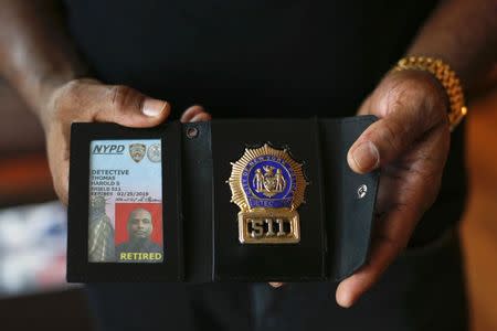 The badge and identification card of retired NYPD detective Harold Thomas are seen in West Hempstead, New York December 17, 2014. REUTERS/Shannon Stapleton