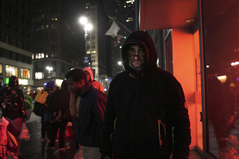 Jose Ruiz, 58, poses for a portrait after eating a meal donated by Taheni Mediterranean Grill and Muslims Giving Back, in Herald Square, New York, on Sunday, April 26, 2020. "This is wonderful … it's the whole world," says Ruiz, who said he has been homeless for two years. A Catholic, he cares little about Ramadan. What's important, he says, is that these visitors "do it from the heart." (AP Photo/Wong Maye-E)