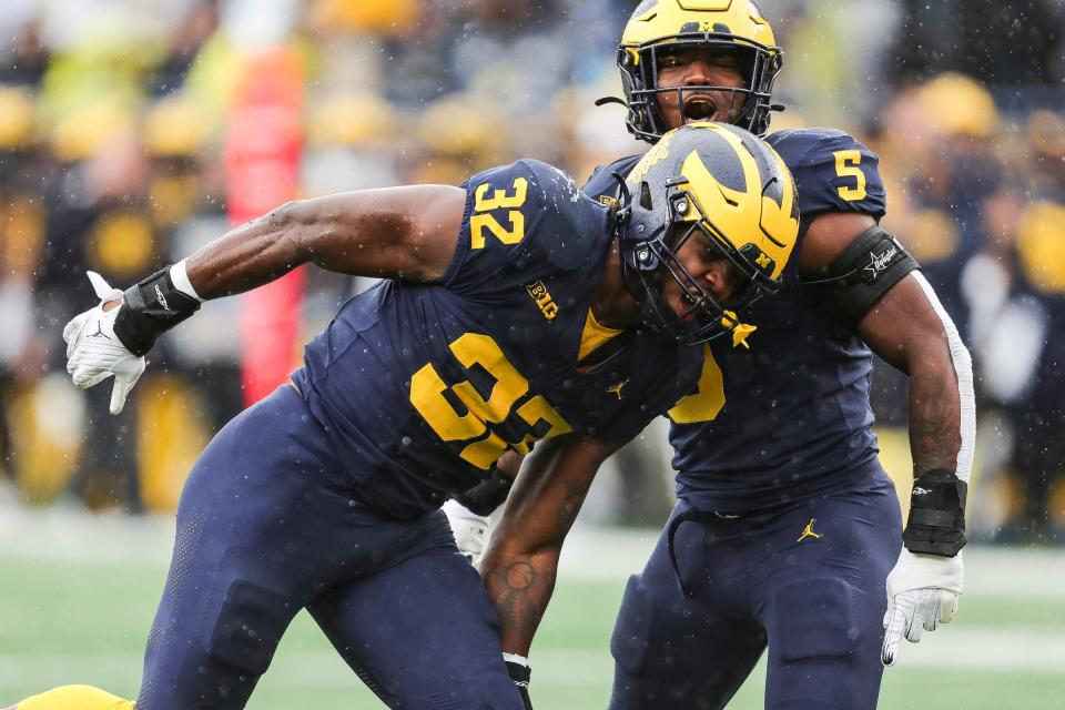 Michigan defensive end Jaylen Harrell celebrates a play against Indiana with defensive end Josaiah Stewart during the second half of U-M's 52-7 win over Indiana on Saturday, Oct. 14, 2023, in Ann Arbor.