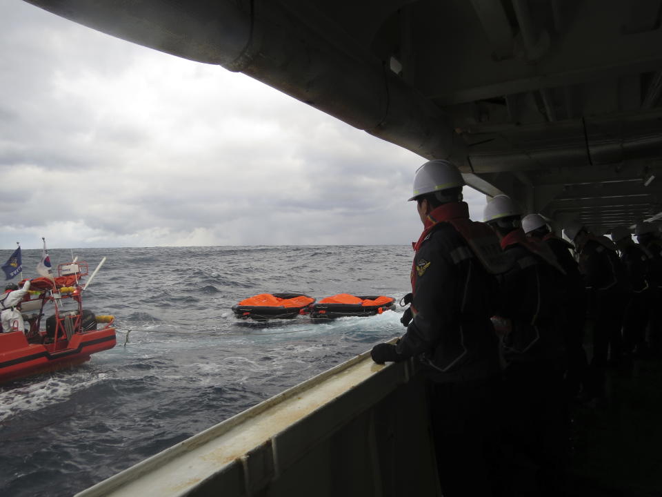 In this photo provided by the Korea Coast Guard, members of South Korea coast guard conduct a search operation in waters between South Korea and Japan, Wednesday, Jan. 25, 2023. South Korean and Japanese coast guards were searching for crew members of a cargo ship that sank early Wednesday in waters between South Korea and Japan, South Korean officials said Wednesday. (The Korea Coast Guard via AP)