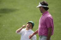 Bubba Watson walks with his daughter, Dakota on the first hole during the par-3 contest at the Masters golf tournament at Augusta National Golf Club Wednesday, April 10, 2024, in Augusta, GA. (AP Photo/Ashley Landis)