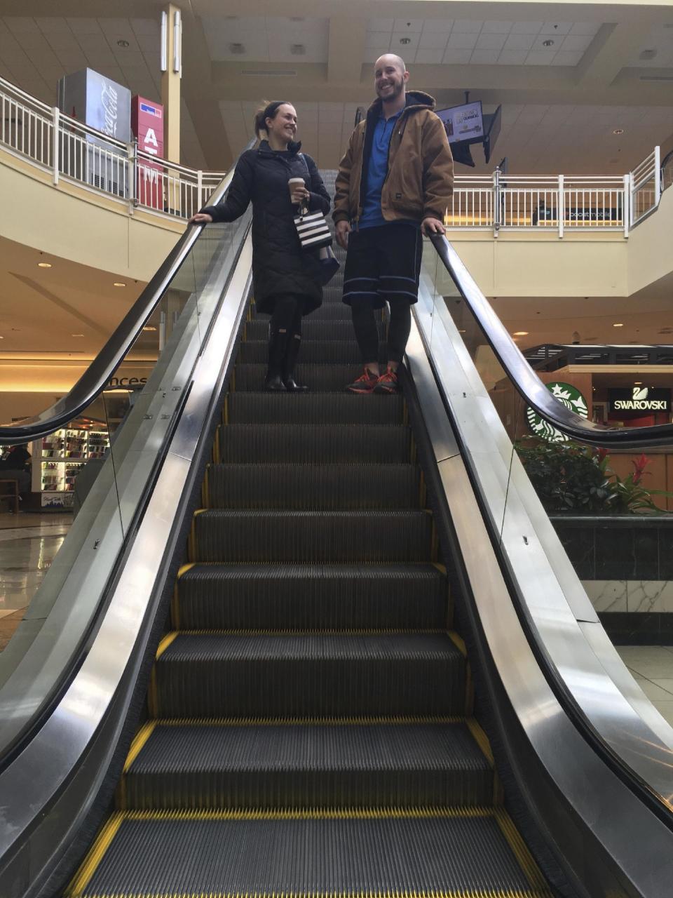 Courtney Taylor and her boyfriend, Zach Tobias, ride the escalator at a mall in Whitehall, Pa., on Feb. 9, 2017. Taylor and Tobias don’t mix shopping with politics, but say it seems to be happening more often during the Donald Trump era as activists who either oppose or support the president target stores and brands for boycotts. (AP Photo/Michael Rubinkam)