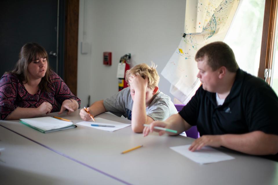 Kyle Hampton, 13, is guided to talk about goals and feelings with resource specialist Brandon Large, right, and case manager Sydney Ray at the Marion County Family Resource Center.