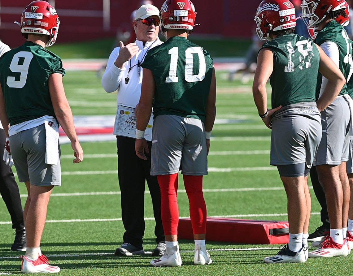 Fresno State football coach Jeff Tedford talks with his quarterbacks on the first day of spring practice, Monday March 21, 2022.