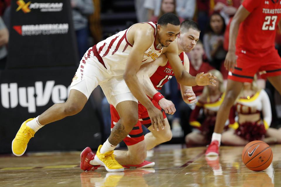 Iowa State guard Talen Horton-Tucker, left, fights for a loose ball with Texas Tech guard Matt Mooney during the first half of an NCAA college basketball game, Saturday, March 9, 2019, in Ames, Iowa. (AP Photo/Charlie Neibergall)
