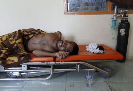 A migrants believed to be Rohingya rests on a stretcher at a shelter after being rescued from boats, in Lhoksukon, Indonesia's Aceh Province May 11, 2015. REUTERS/Roni Bintang