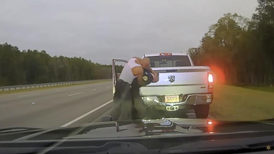 This still image provided by Camden County Sheriff's Office shows the police dash camera video of a traffic stop involving a sheriff's deputy and Leonard Cure on Monday, Oct. 16, 2023, in Camden County, Ga. The deputy fatally shot the Black man at point-blank range during a traffic stop after the man, who had been wrongfully imprisoned years ago, grabbed the officer by the neck and was forcing his head backward, according to video released by a sheriff Wednesday, Oct. 18. (Camden County Sheriff's Office via AP)