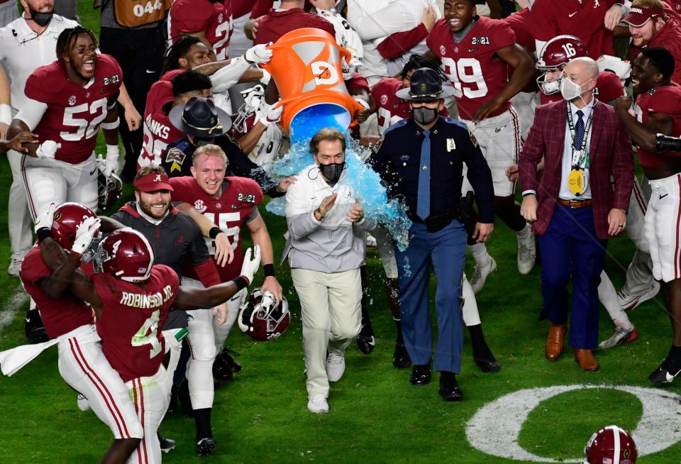 Crimson Tide head coach Nick Saban is dunked with Gatorade after defeating the Ohio State Buckeyes in the 2021 College Football Playoff National Championship Game.