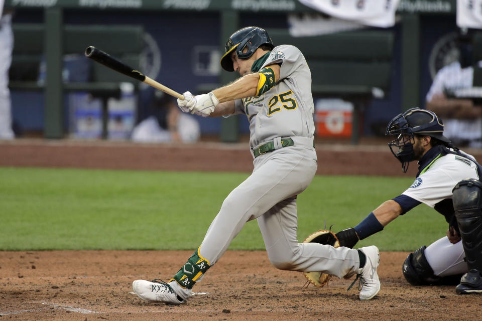 Oakland Athletics' Stephen Piscotty hits an RBI double during the fifth inning of a baseball game against the Seattle Mariners, Monday, Aug. 3, 2020, in Seattle. (AP Photo/Ted S. Warren)