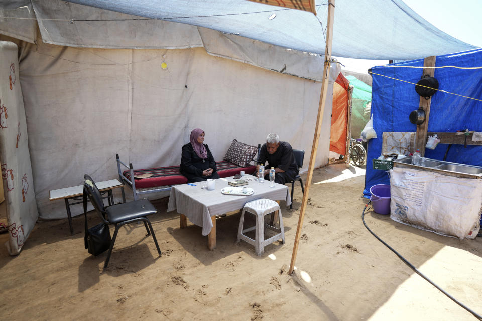 Ibrahim Abu Shaaban sits with his wife in their tent on Thursday, June 13, 2024 in Deir al Balah, Gaza Strip. The couple had planned to perform the Hajj pilgrimage this year, but like all Palestinians in the coastal enclave of Gaza were not able to travel to Mecca because of the closure of the Rafah crossing in May when Israel extended its ground offensive to the strip's southern city of Rafah on the border with Egypt. (AP Photo/Abdel Kareem Hana)
