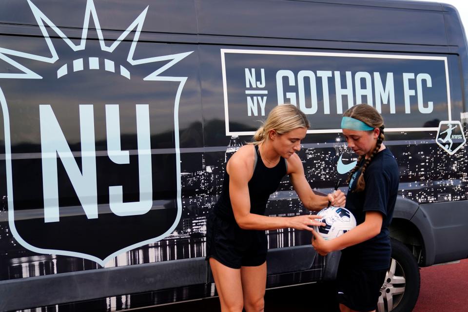 Gotham FC midfielder Kristie Mewis signs a soccer ball for Aoife Brady, 12, a player with Nirvana Football Club, during a youth clinic at Brookdale Park soccer field in Montclair on Monday, June 13, 2022. 