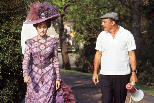 <p>Pierluigi Praturlon/Reporters Associati & Archivi/Mondadori Portfolio/Everett Collection</p> Barbra Streisand and Gene Kelly on the set of 'Hello, Dolly!'