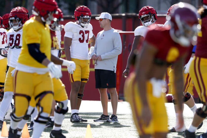 LOS ANGELES, CA - MARCH 28: USC head football coach Lincoln Riley, right, with defensive lineman Devan Thompkins (37) at spring football practice at Howard Jones/Brian Kennedy Fields on the Campus of The University of Southern California on Tuesday, March 28, 2023 in Los Angeles, CA. (Gary Coronado / Los Angeles Times)