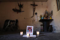 This Feb. 13, 2020 photo shows a memorial for Juan Carlos Medina Serrano in his family's living room, the day his remains were buried, in Irapuato, Guanajuato state, Mexico. Armed men took the 32-year-old from his house on Dec. 3. A few days later, authorities found 19 rotting bodies buried in a backyard in a nearby town, but it took two months for them to notify his wife that her husband was one of the bodies. (AP Photo/Rebecca Blackwell)