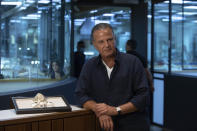 Isaac Levy, owner of Israeli jewelry company Yvel speaks during an interview with the Associated Press next to parts of a mask in Motza near Jerusalem, Sunday, Aug. 9, 2020. An Israeli jewelry company is working on what it says will be the world's most expensive coronavirus mask, a gold, diamond-encrusted face covering with a price tag of $1. 5 million. (AP Photo/Sebastian Scheiner)