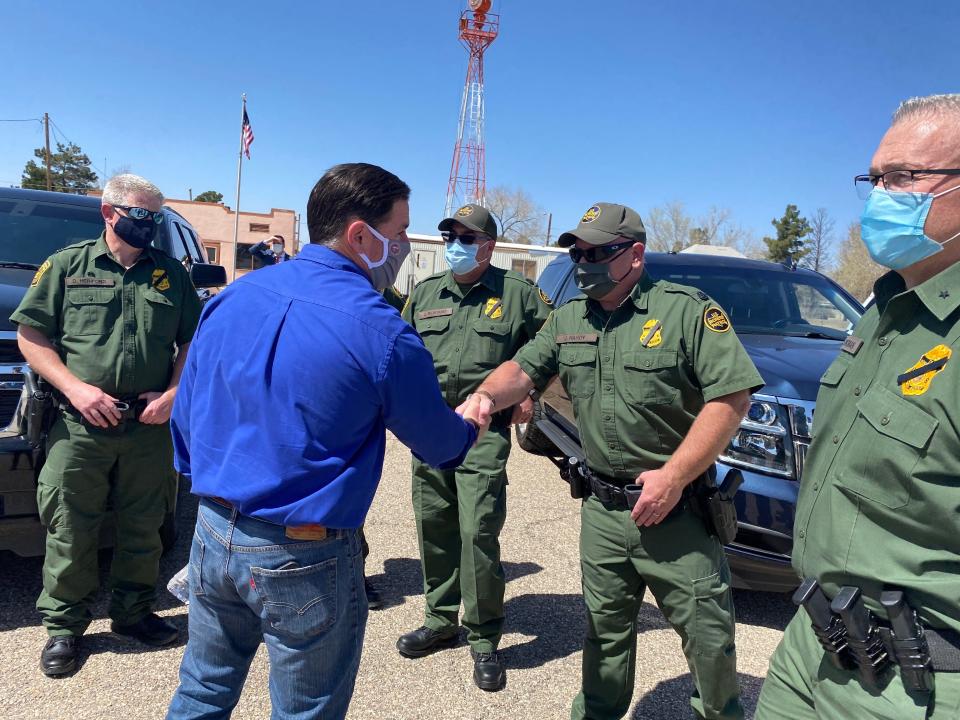 Gov. Doug Ducey (center left) meets with law enforcement and safety officials during a visit to the U.S.-Mexico border on March 19, 2021.