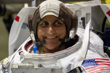 NASA Commercial Crew astronaut Sunita Williams smiles as she wears her space suit at NASA's Neutral Buoyancy Laboratory (NBL) training facility near the Johnson Space Center in Houston,