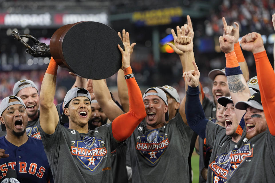 Houston Astros shortstop Jeremy Pena celebrates with the trophy after their 4-1 World Series win against the Philadelphia Phillies in Game 6 on Saturday, Nov. 5, 2022, in Houston. (AP Photo/David J. Phillip)